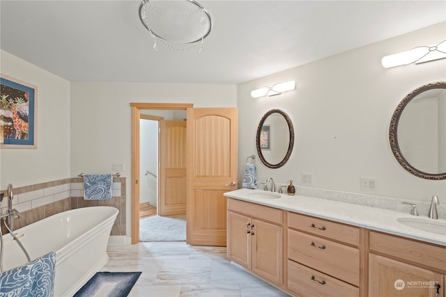 bathroom featuring vanity, a bath, and tile walls