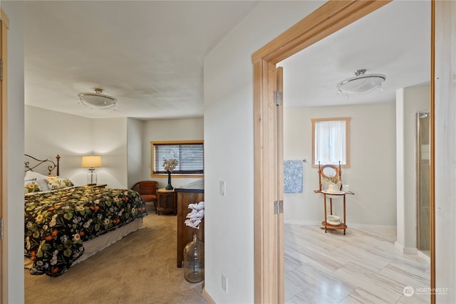 bedroom featuring light colored carpet