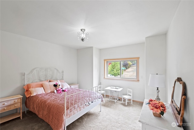 bedroom featuring a notable chandelier and carpet flooring