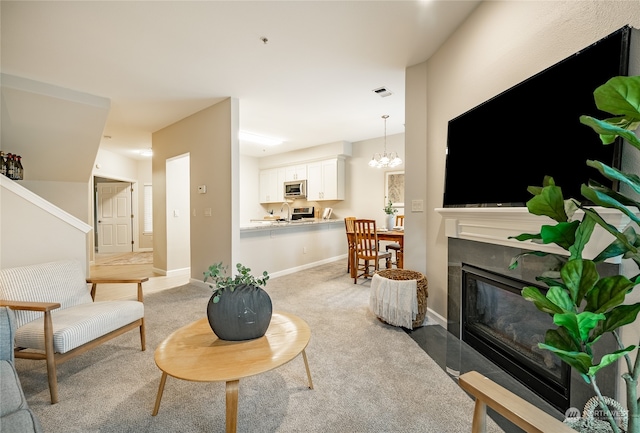 carpeted living room with a chandelier