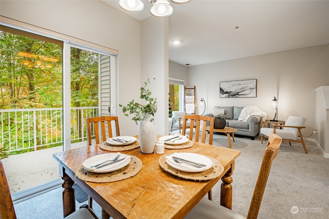 dining area featuring plenty of natural light and light carpet