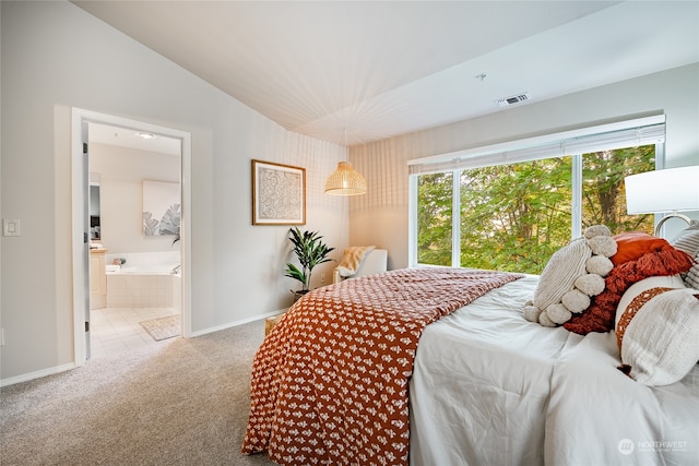 carpeted bedroom with lofted ceiling and connected bathroom