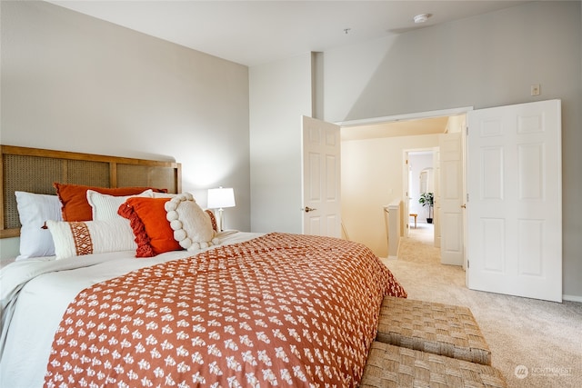 carpeted bedroom featuring high vaulted ceiling