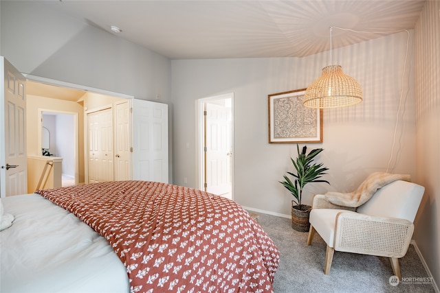 carpeted bedroom featuring vaulted ceiling and a closet