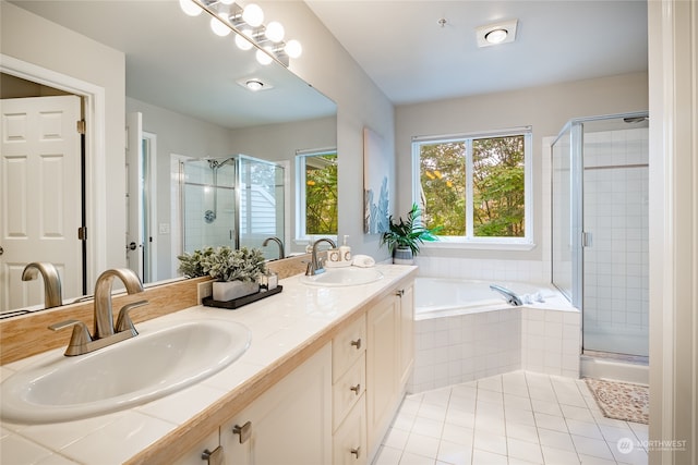 bathroom with tile patterned flooring, vanity, and independent shower and bath