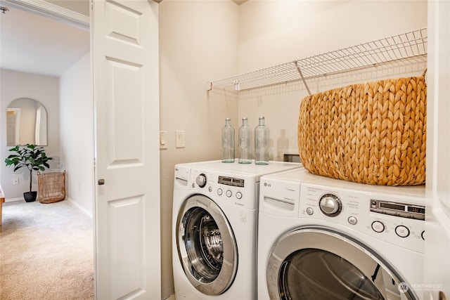 clothes washing area featuring independent washer and dryer and carpet floors