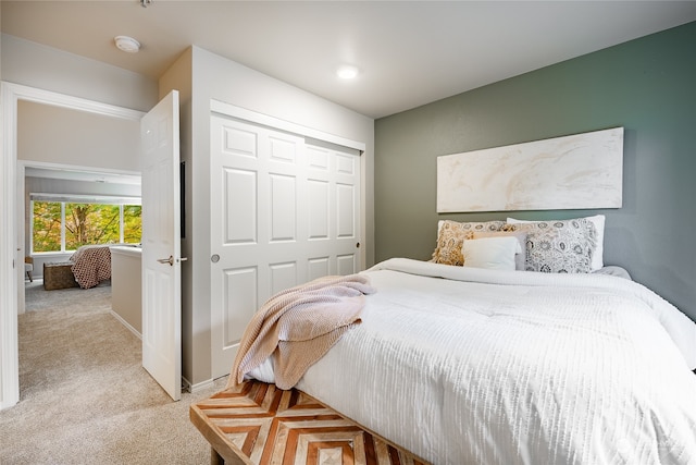 bedroom with a closet and light colored carpet