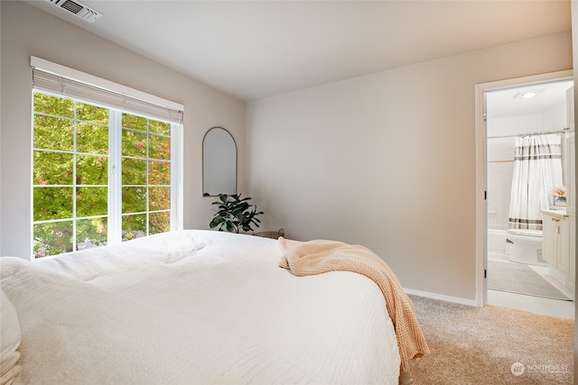 carpeted bedroom with ensuite bath