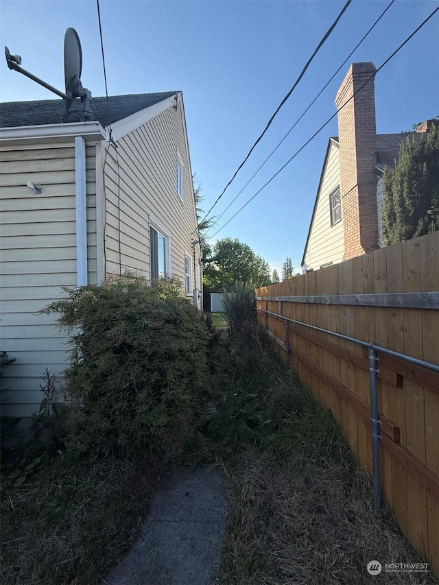 5410 S Cushman Ave, Tacoma, WA 98408 - view of side of property featuring fence and roof with shingles