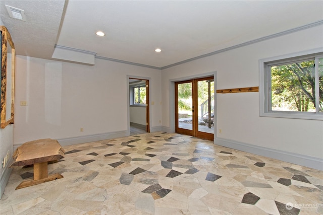 unfurnished room with crown molding and french doors