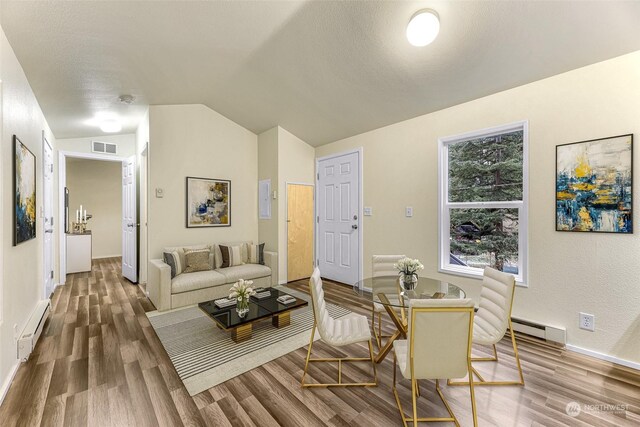 4220 Brays Way, Bellingham, WA 98226 - living area with a baseboard heating unit, wood finished floors, baseboard heating, and vaulted ceiling