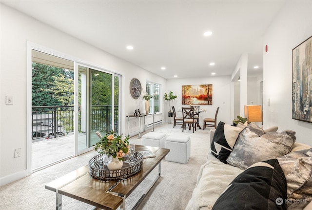 living room featuring light colored carpet and a baseboard heating unit