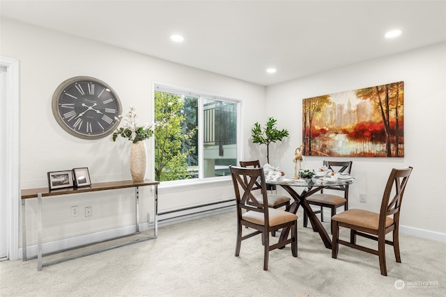 carpeted dining area featuring baseboard heating