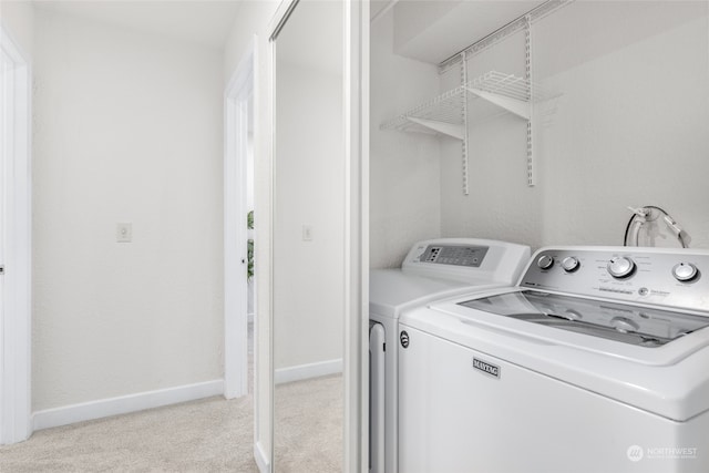 laundry area featuring independent washer and dryer and light colored carpet