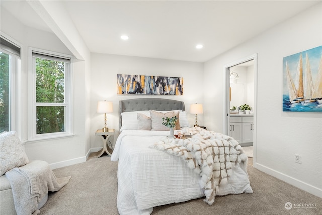 carpeted bedroom featuring ensuite bathroom