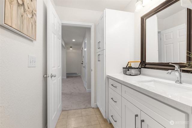 bathroom featuring vanity, baseboard heating, and tile patterned flooring