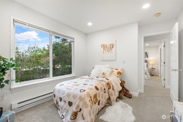 bedroom featuring a baseboard radiator and light colored carpet