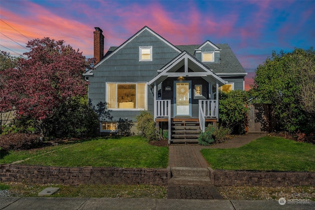 view of front of home featuring a porch and a lawn