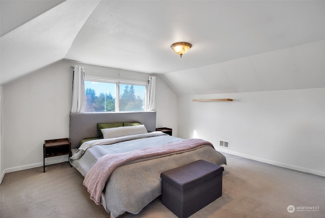 carpeted bedroom featuring lofted ceiling