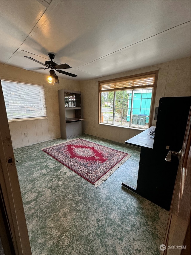 interior space with ceiling fan