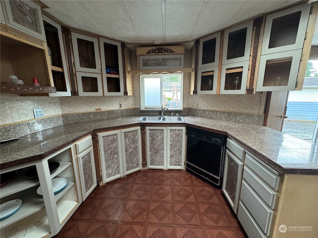 kitchen featuring dishwasher, dark parquet flooring, sink, and a textured ceiling