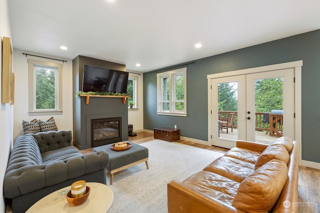 living room with french doors, light hardwood / wood-style flooring, and plenty of natural light