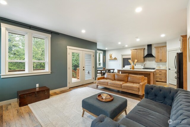 living room featuring french doors and light wood-type flooring