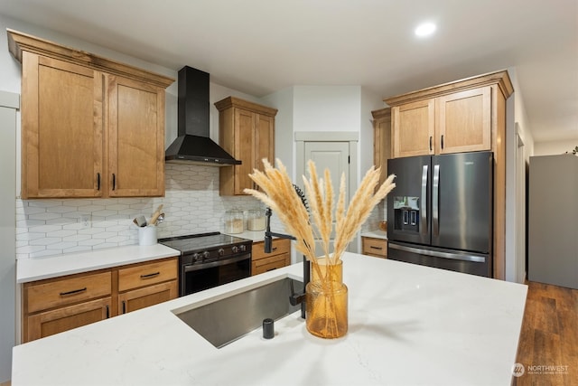 kitchen featuring wall chimney range hood, stainless steel refrigerator with ice dispenser, backsplash, electric range, and dark hardwood / wood-style flooring