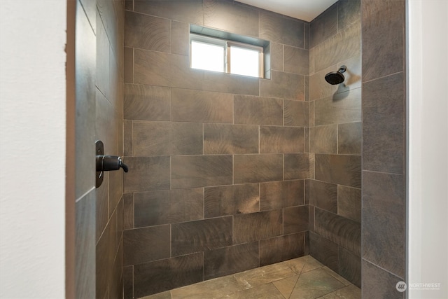 bathroom with tiled shower