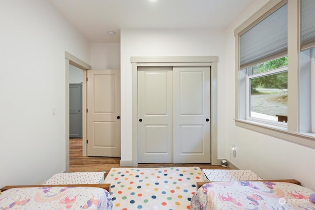 bedroom featuring a closet and light wood-type flooring