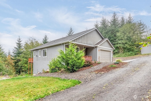 view of home's exterior with a yard and a garage