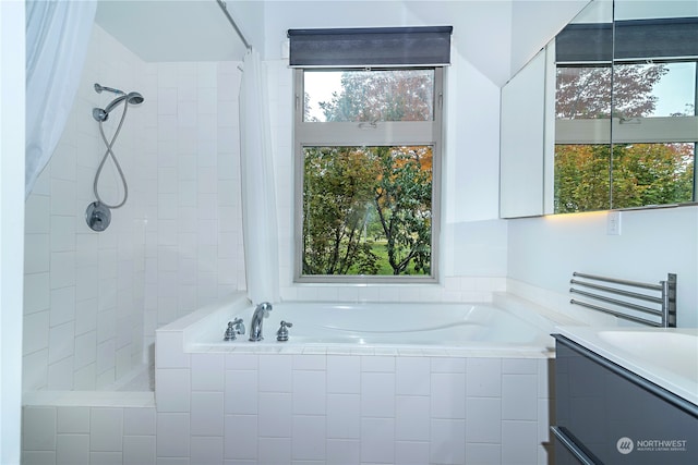 bathroom with vanity, a wealth of natural light, and separate shower and tub