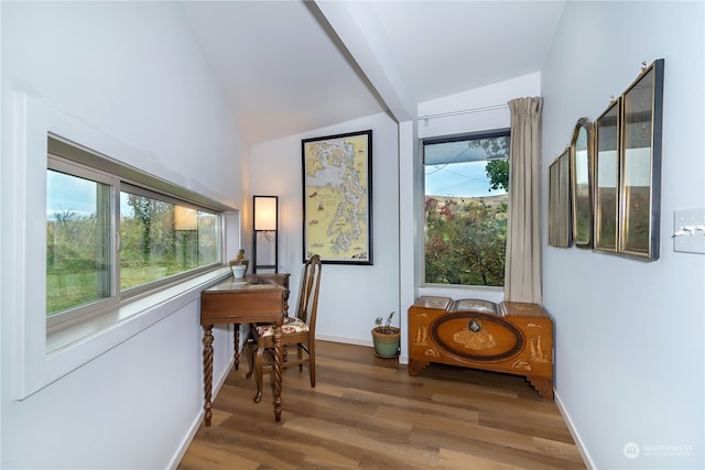 interior space featuring wood-type flooring and lofted ceiling with beams