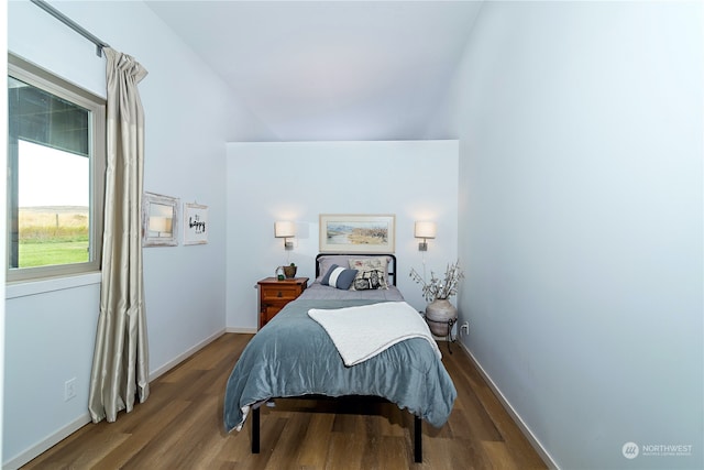 bedroom featuring hardwood / wood-style floors and lofted ceiling