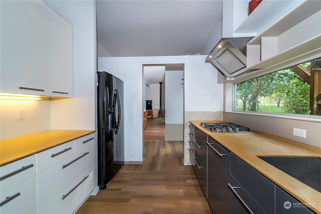 kitchen with dark hardwood / wood-style flooring, white cabinetry, stainless steel gas stovetop, and black fridge with ice dispenser