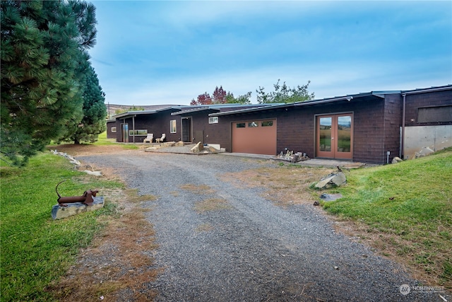 view of front facade with a garage and a front lawn