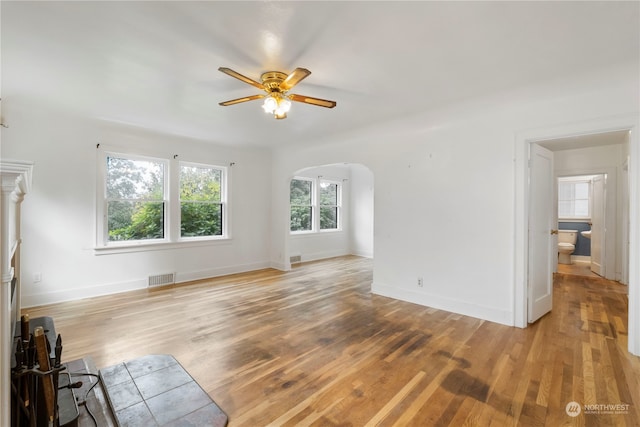 unfurnished living room with light hardwood / wood-style flooring and ceiling fan