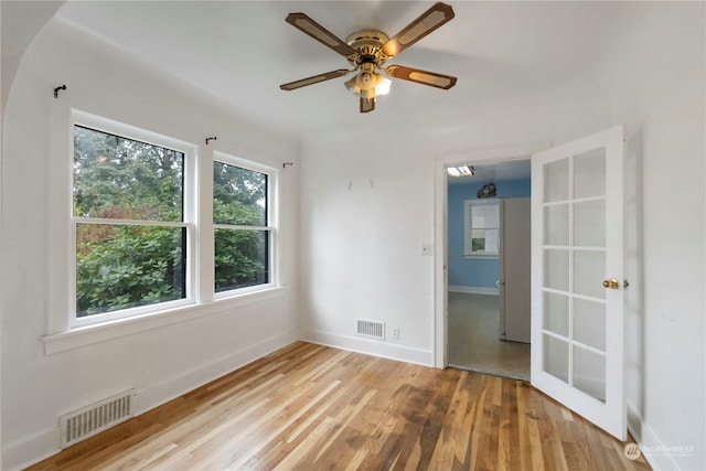 empty room with light hardwood / wood-style floors and ceiling fan