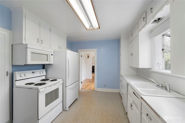 kitchen with sink, white cabinets, and white appliances