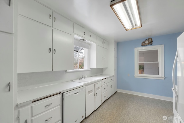 kitchen with white appliances, sink, and white cabinets