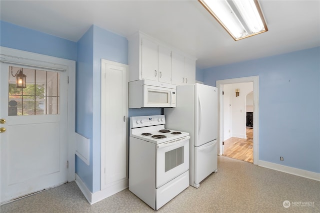 kitchen featuring white cabinets and white appliances