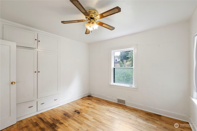 unfurnished bedroom featuring light hardwood / wood-style flooring, a closet, and ceiling fan