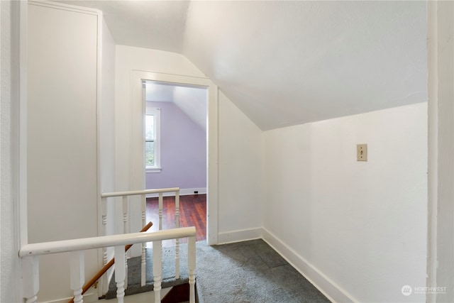 interior space featuring lofted ceiling and carpet flooring