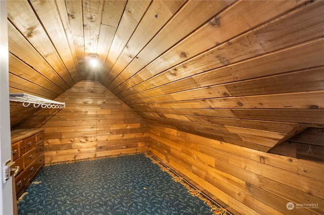 additional living space featuring wood ceiling, lofted ceiling, wooden walls, and carpet