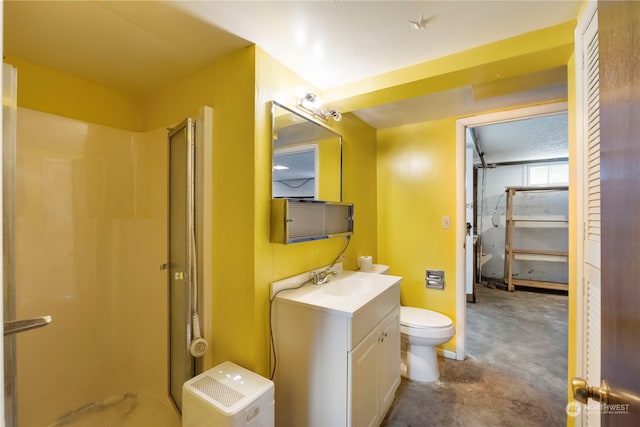 bathroom with vanity, toilet, and a shower