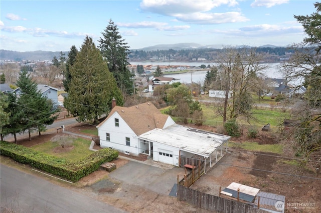 birds eye view of property featuring a water and mountain view