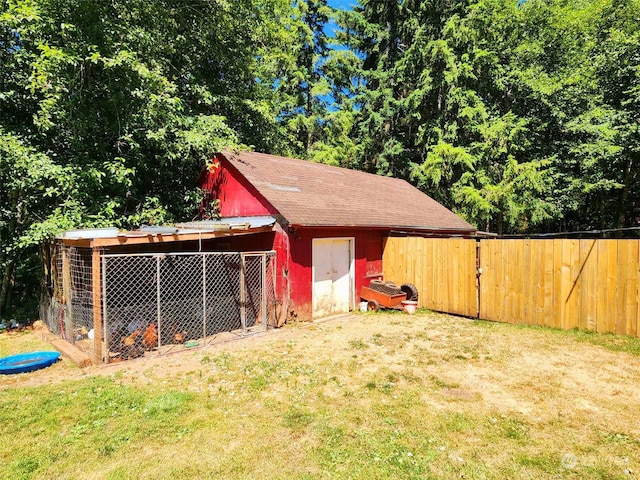 view of outbuilding featuring a lawn