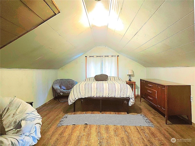 bedroom featuring vaulted ceiling, wood finished floors, and baseboards