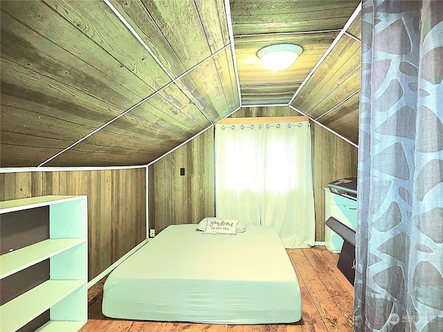 additional living space with hardwood / wood-style floors, wooden ceiling, wood walls, and vaulted ceiling
