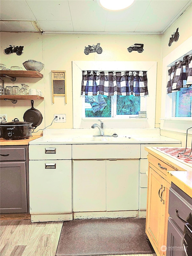 kitchen with a healthy amount of sunlight, gray cabinetry, and light countertops
